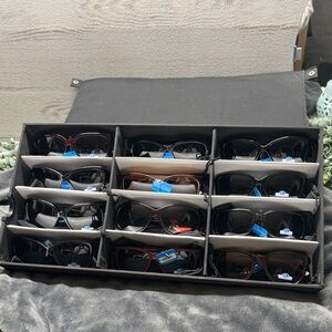 NWT 12 pair polarized sunglasses with storage case.